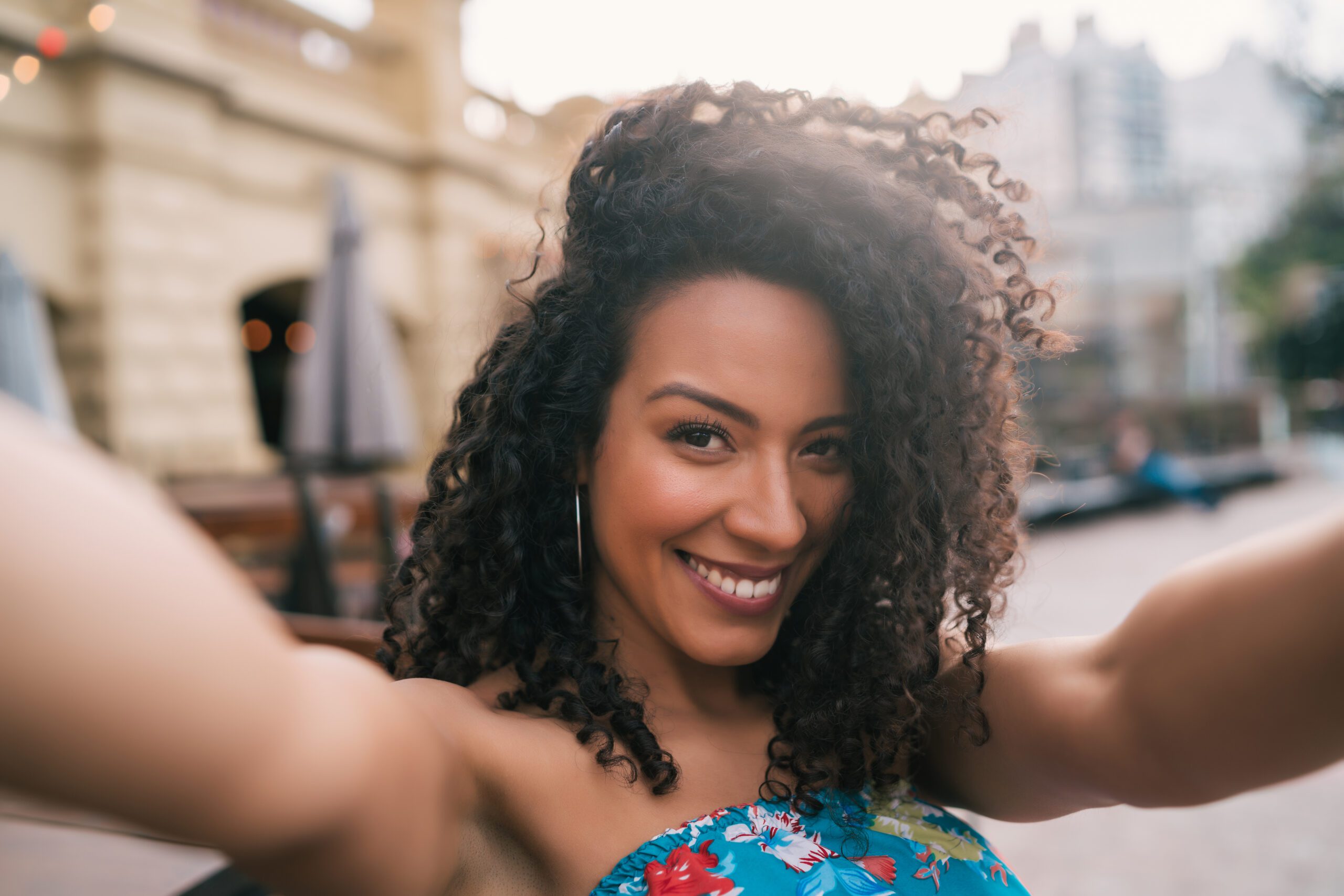 Afro american woman taking a selfie in the city.